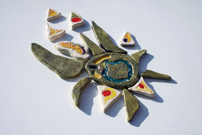 Scultura ceramica di medio formato in argilla bianca con fulcro centrale a effetto lustro iridescente e raggi vellutati in tonalità calde e argento
