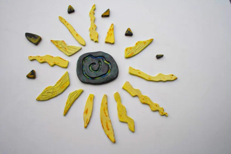 Sole medio-piccolo in argilla nera con fulcro verde a inclusioni di vetro fuso e raggi esterni giallo-arancio.
